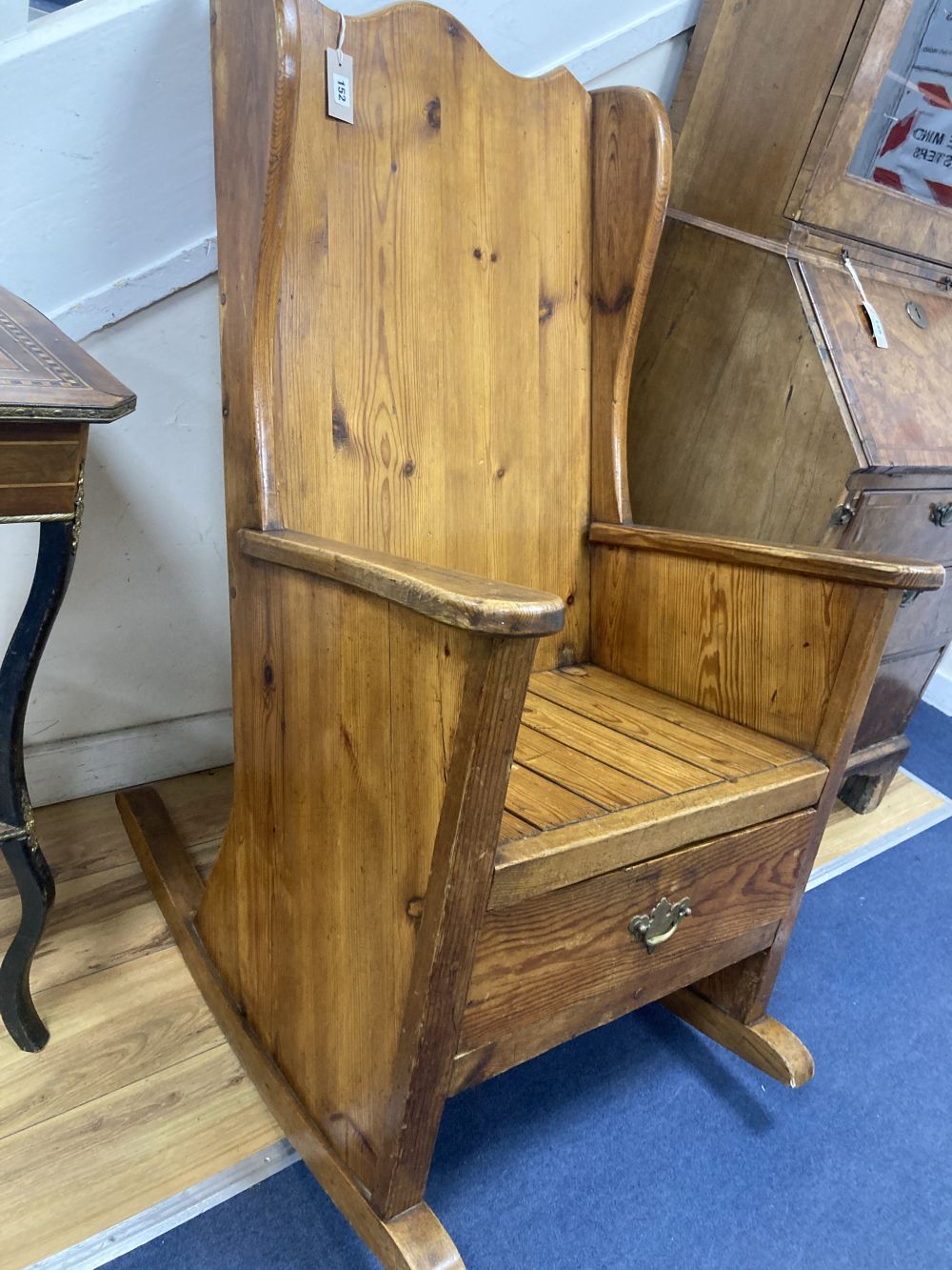 A pitch pine rocking armchair, width 66cm, height 111cm